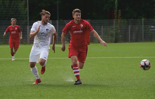 Free Two men in action during a competitive soccer match on a green field. Stock Photo