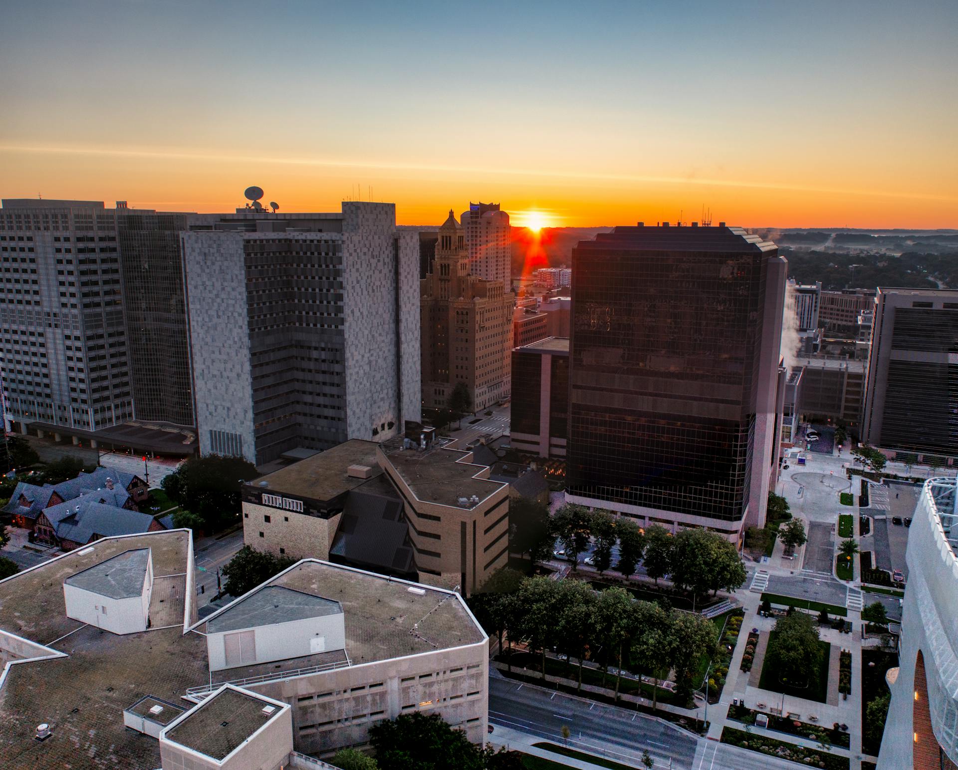 Aerial view of Rochester MN cityscape with sunset illuminating the skyline.