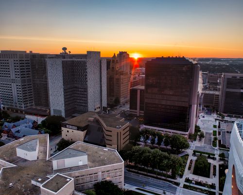 Free Aerial view of Rochester MN cityscape with sunset illuminating the skyline. Stock Photo