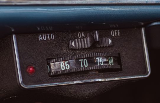 A vintage car dashboard showing its dials.