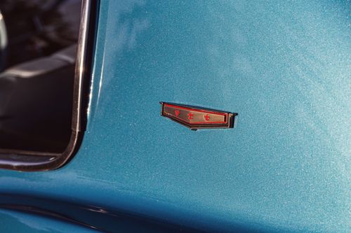 Free Detailed shot of a 1966 Chevrolet Caprice's emblem on a blue vintage car, showcasing classic automotive design. Stock Photo