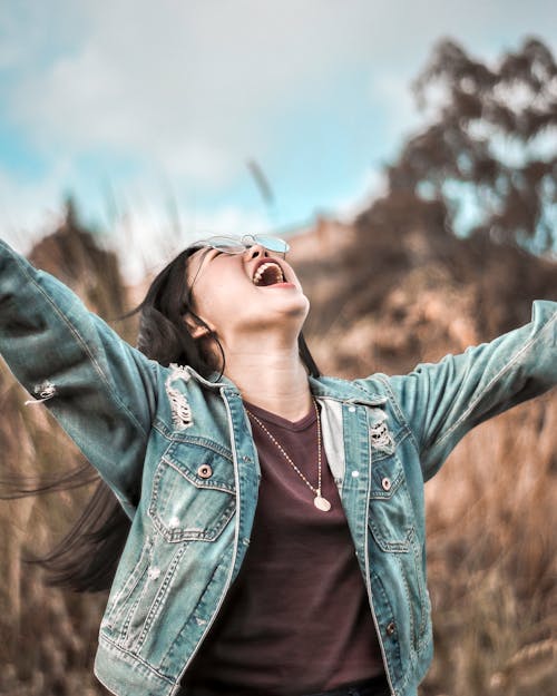 Photo Of Woman Looking Up With Arms Wide Open 
