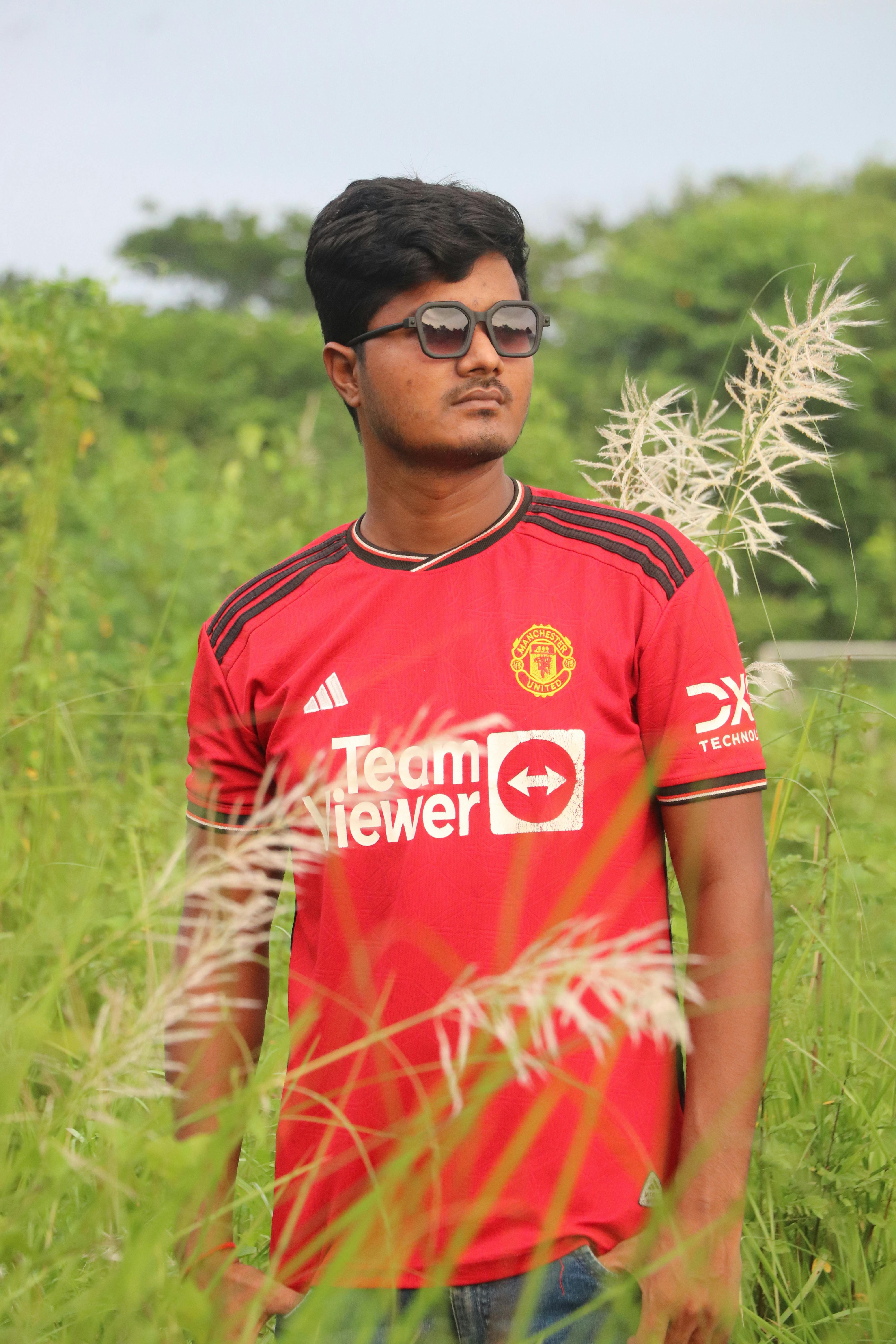 Portrait of a young South Asian man wearing sunglasses outdoors in Rangpur, Bangladesh.