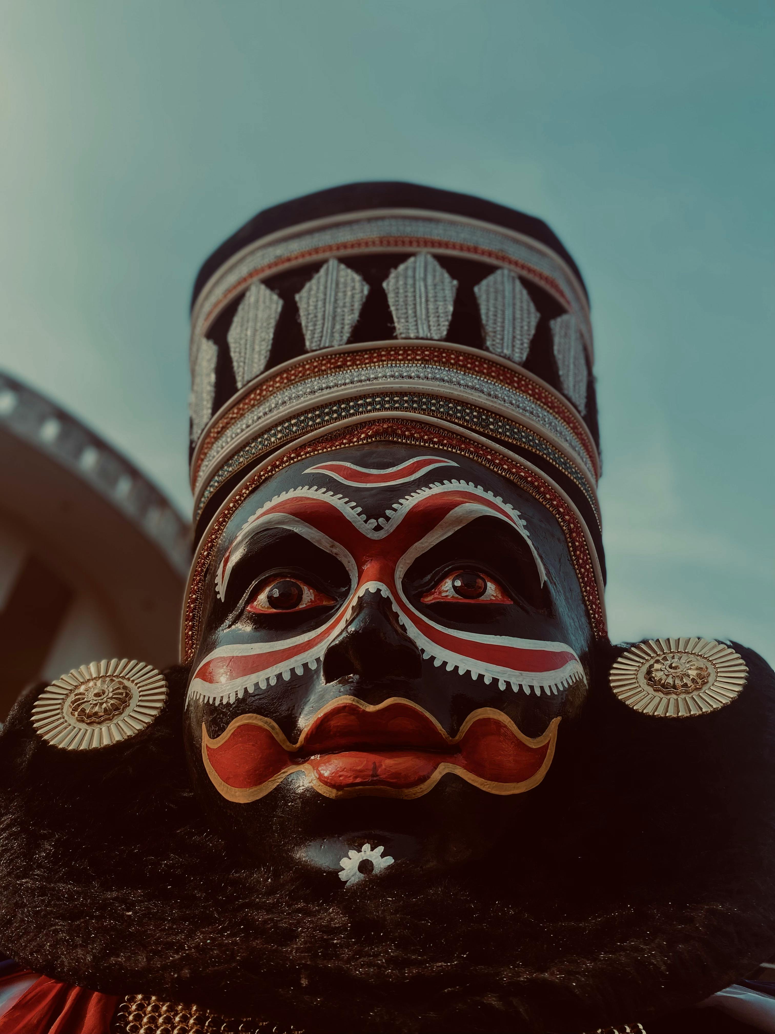 a black face with a red nose and a red hat