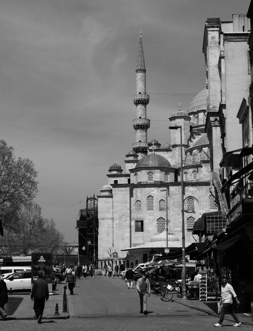 Free Black and white shot of a historic mosque in Istanbul with people walking. Stock Photo