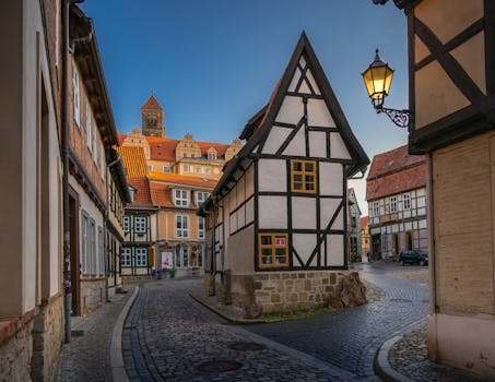 Explore the quaint medieval streets and timber-framed houses of Quedlinburg, Germany during a serene daytime stroll.