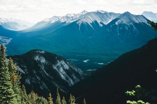 Free Breathtaking view of the Rocky Mountains in Banff, showcasing lush valleys and rugged peaks. Stock Photo