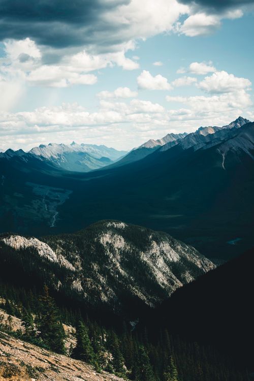 Free Breathtaking aerial view of Banff's majestic mountains and lush forest landscape. Stock Photo