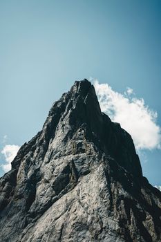 Stunning view of a rocky mountain peak under a bright blue sky in Banff National Park, Canada.