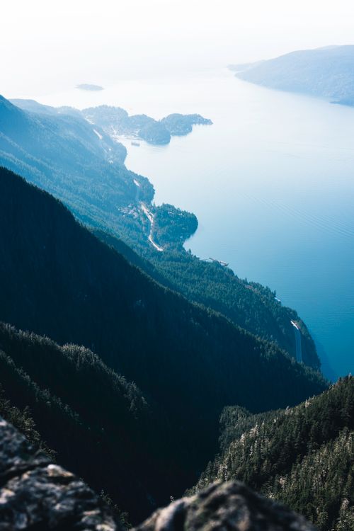 Free Stunning aerial view of coastal mountains and sea in Vancouver, Canada. Perfect for nature-themed projects. Stock Photo