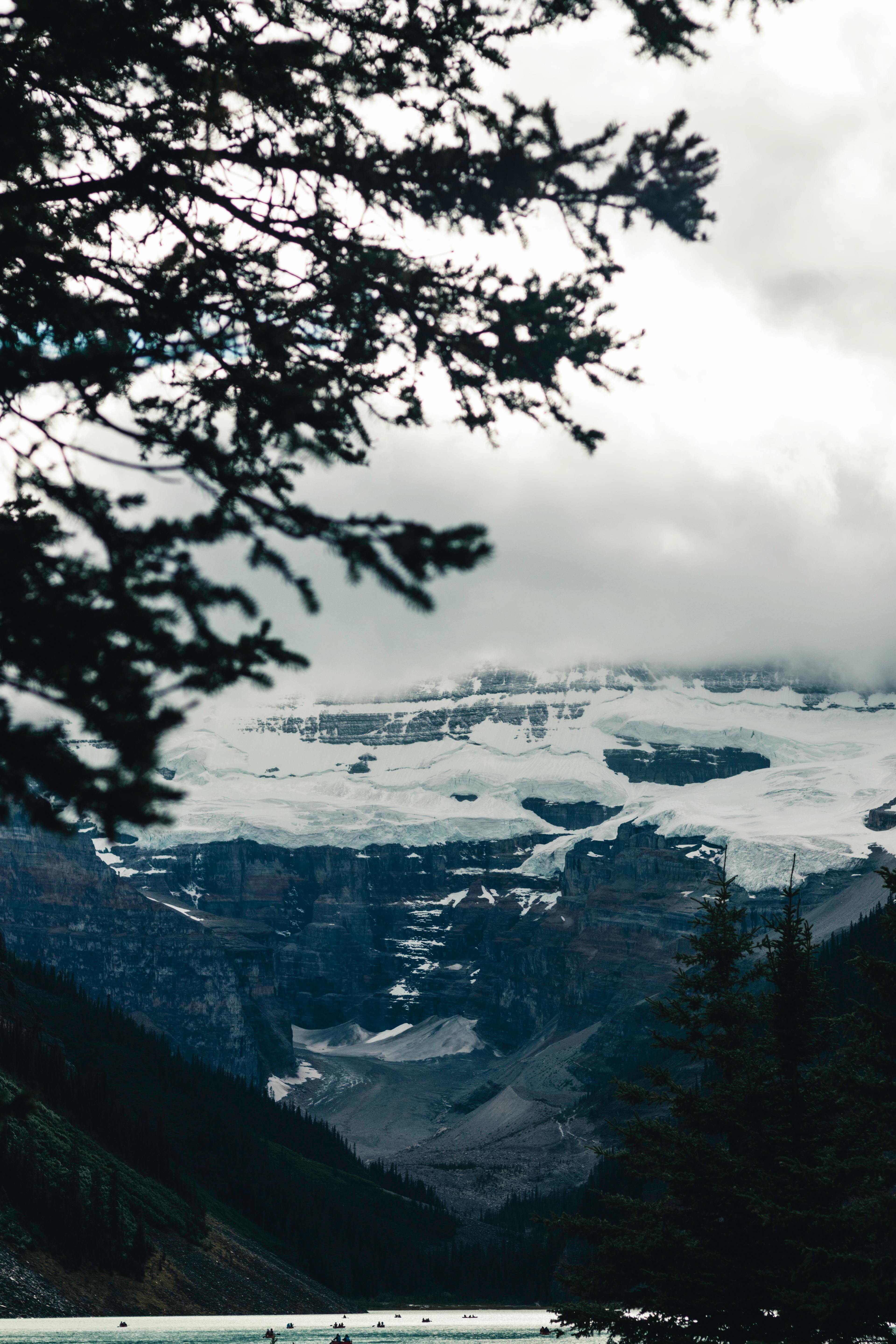 Prescription Goggle Inserts - Majestic view of snowy glacier and mountains through conifer trees in Jasper, Canada.