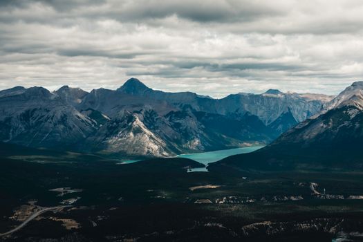 Captivating landscape of Banff's mountain range under an overcast sky.