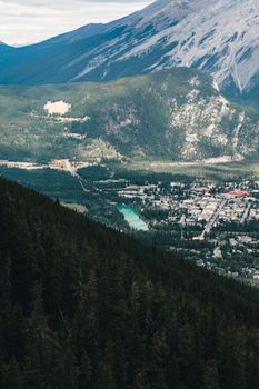 A breathtaking view of Banff, Alberta, nestled in Canadian Rockies with lush forests and towering peaks.