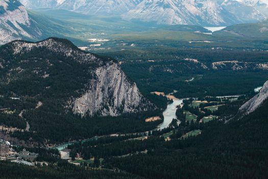 A breathtaking aerial view of the valley in Banff National Park, showcasing the river and lush forests.
