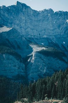 Stunning view of rugged mountains and dense forest in Banff National Park, Canada.