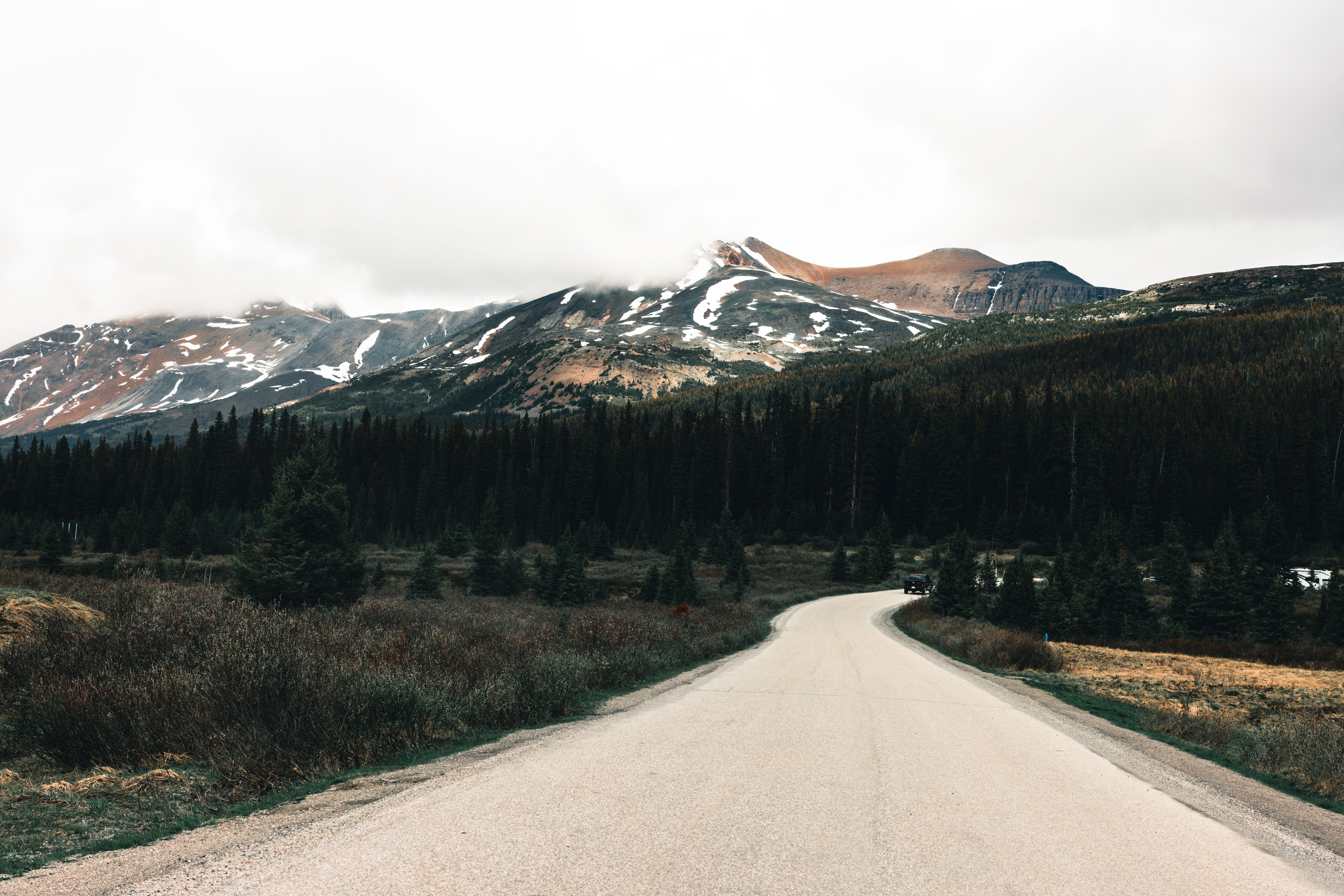 A peaceful mountain road leading to towering peaks in Gibsons, BC during fall.