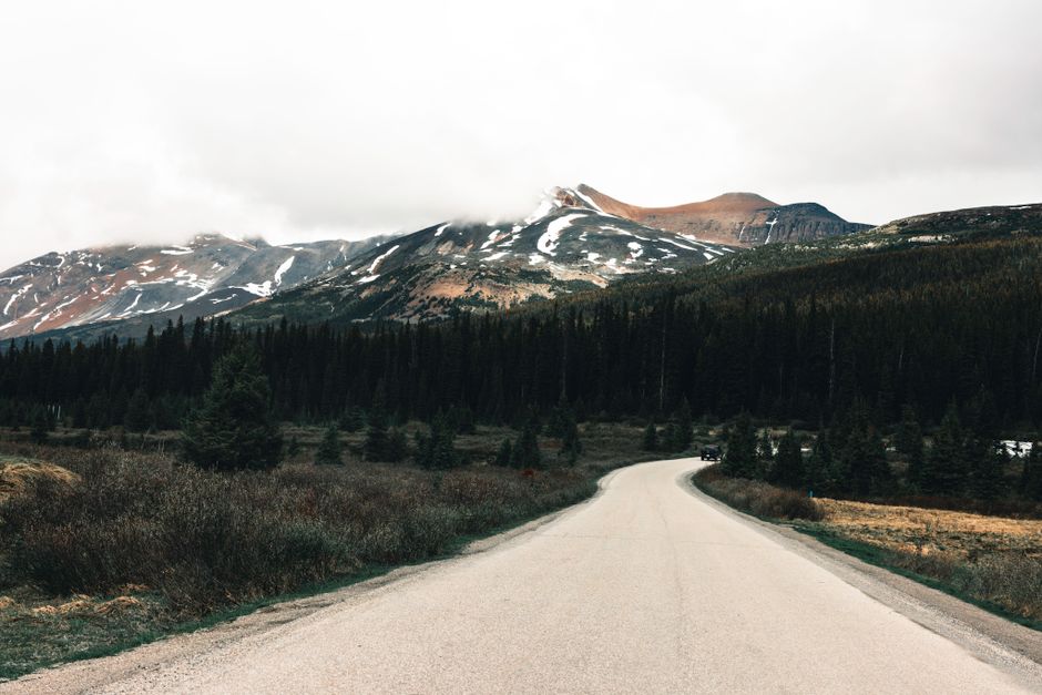 A peaceful mountain road leading to towering peaks in Gibsons, BC during fall.