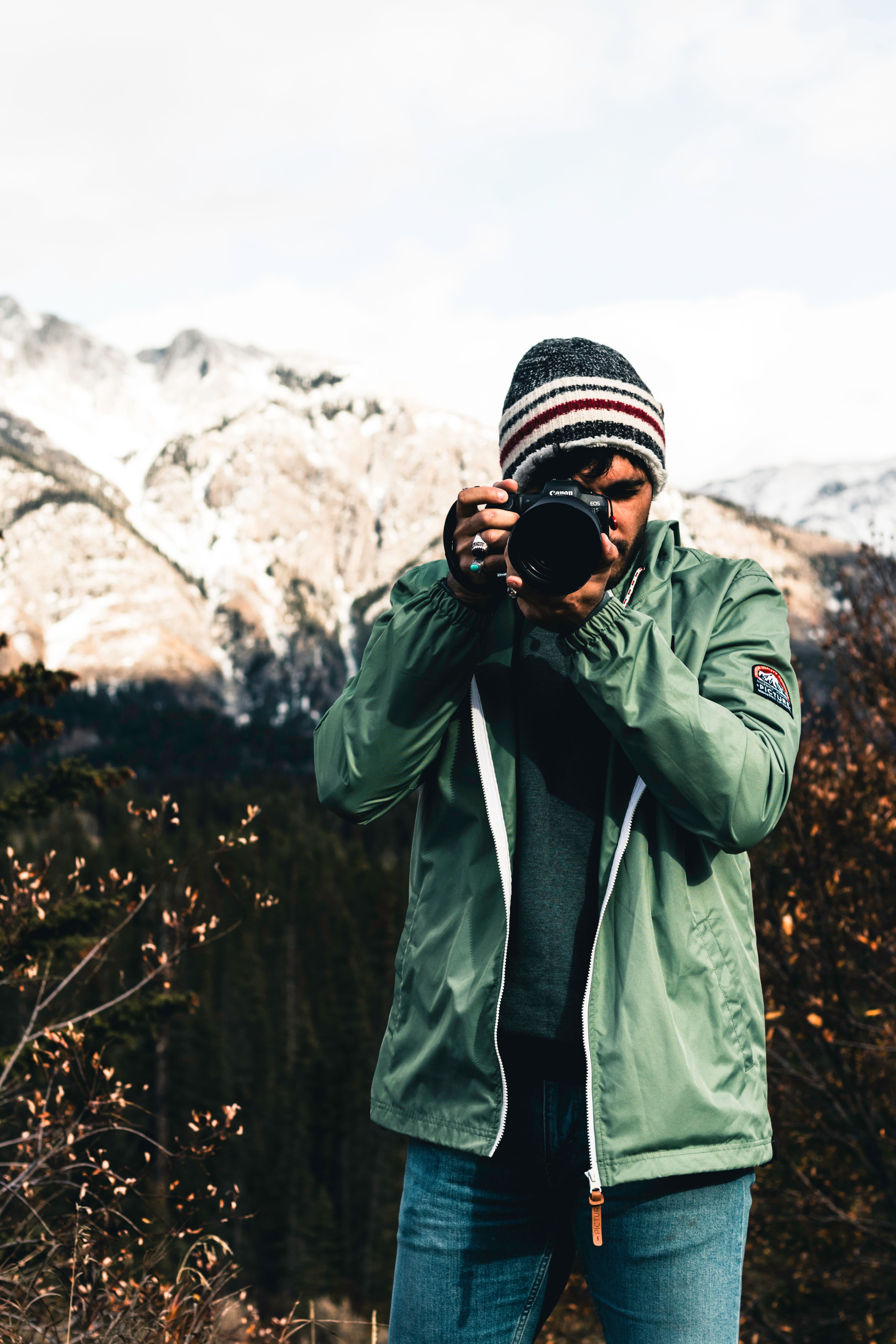 Outdoor portrait of a photographer capturing the scenic beauty of Jasper National Park in Canada.