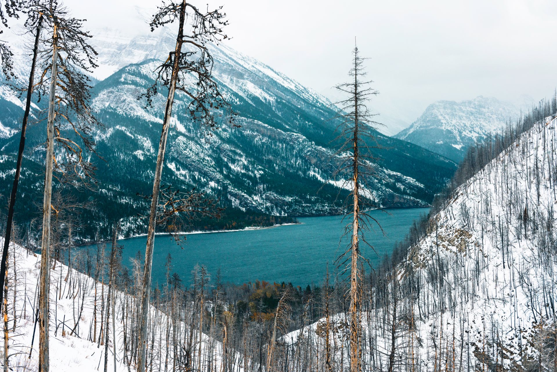 Crystal clear glacial waters reflect the towering peaks of the Northern Rockies