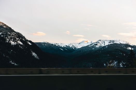 Beautiful snow-capped mountains in Glacier, BC, Canada, captured at sunset during winter.