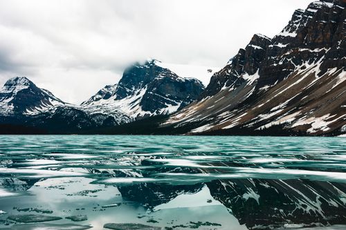 Free Breathtaking view of snow-capped mountains and crystal-clear lake in Glacier, BC. Stock Photo