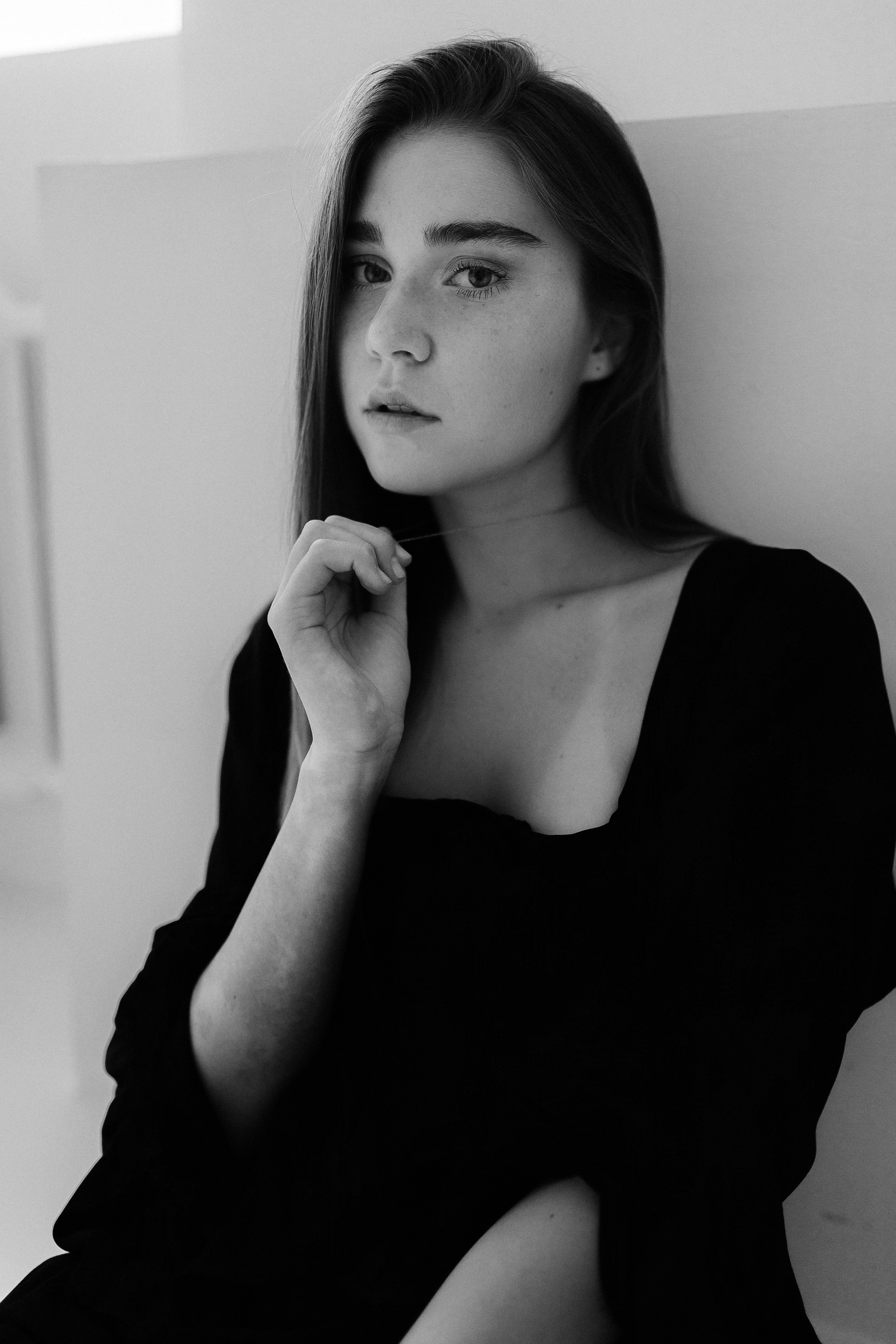 a woman in black and white sitting on a chair