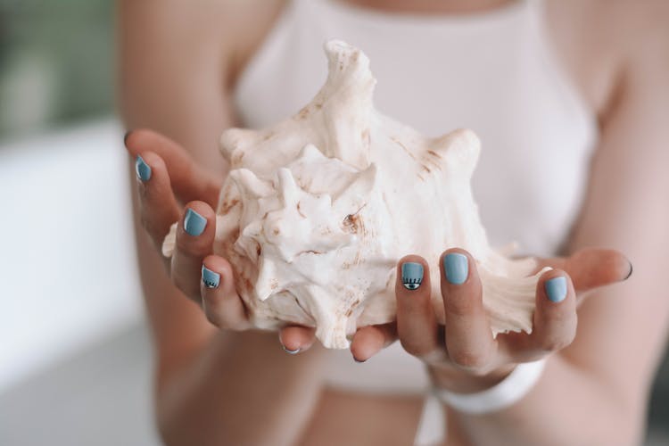 Woman Holding Conch Shell