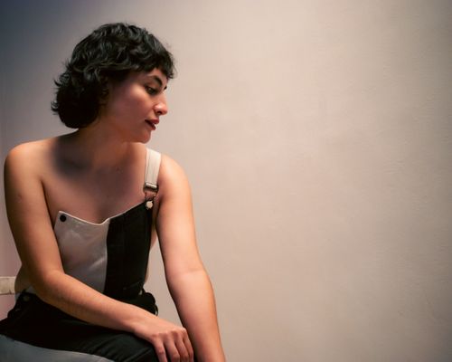 Free A contemplative woman in a stylish black and white outfit in a minimalist setting. Stock Photo