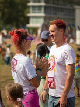 Happy adults engage in a vibrant color run event in Vilnius, Lithuania. Perfect sunny day for celebrations.