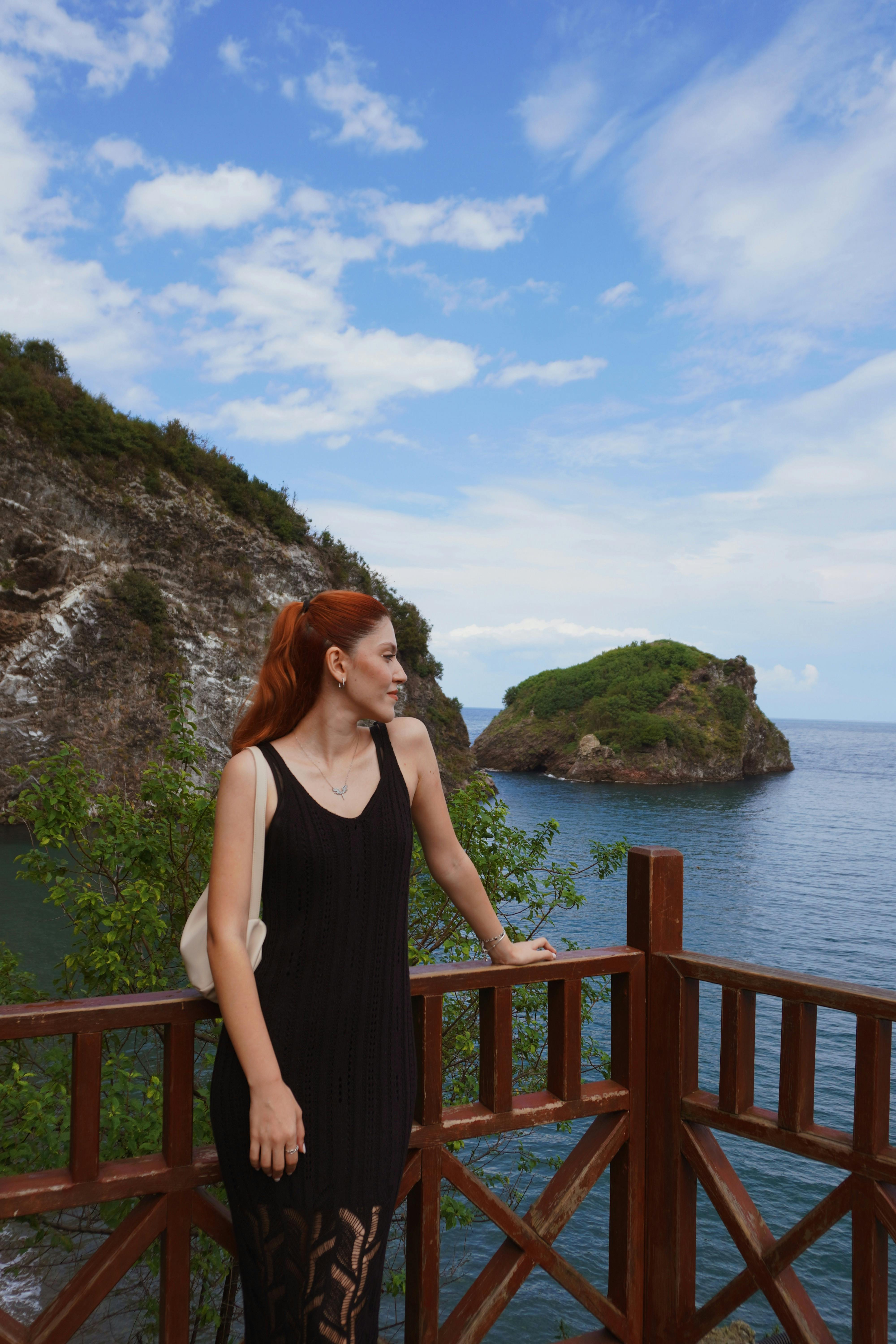 Woman standing on a viewing deck overlooking the sea at Yason Cape in Ordu, Turkey.