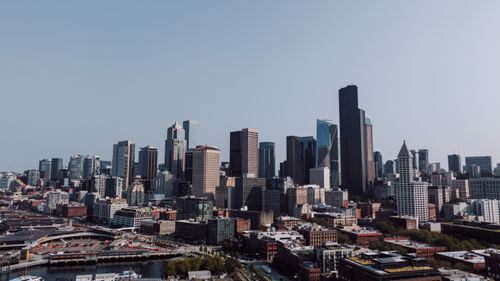 Free Explore Seattle's iconic skyline with modern skyscrapers under a clear, blue sky. Stock Photo