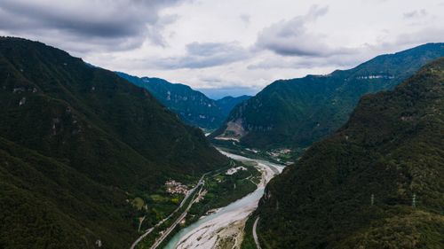 Free Scenic aerial landscape of a river winding through lush valleys in Veneto, Italy with overcast skies. Stock Photo