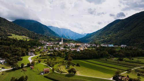 Free Charming aerial view of Seren del Grappa, a quaint Italian town nestled between lush green mountains. Stock Photo