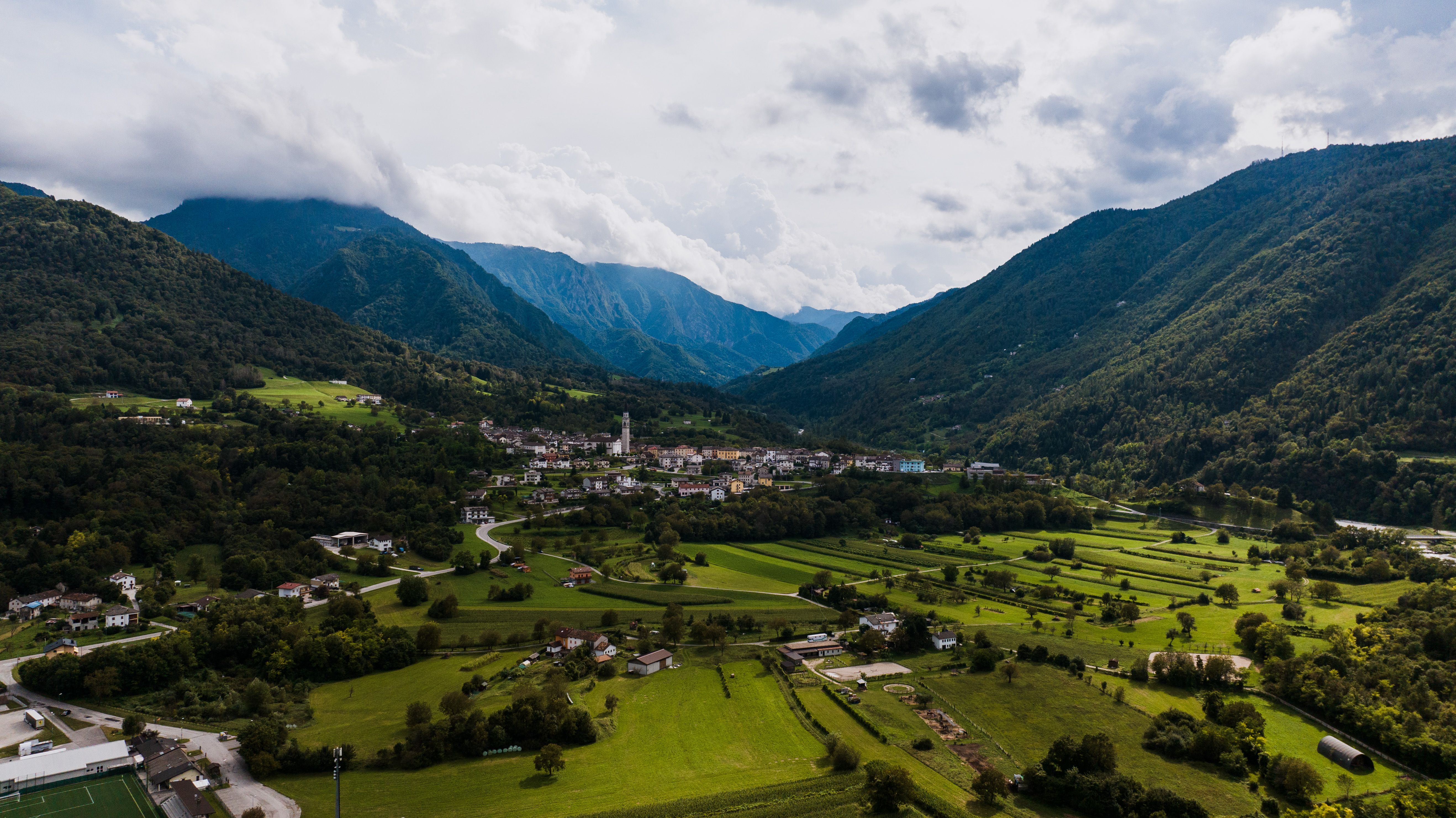 Scenic aerial view of Seren del Grappa, Veneto, Italy, nestled in lush green valleys with mountainous backdrop.