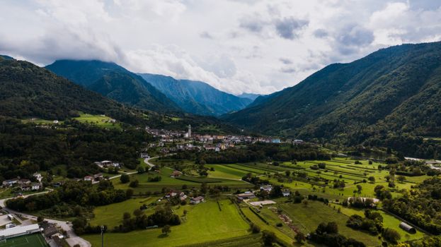 Scenic aerial view of Seren del Grappa, Veneto, Italy, nestled in lush green valleys with mountainous backdrop.