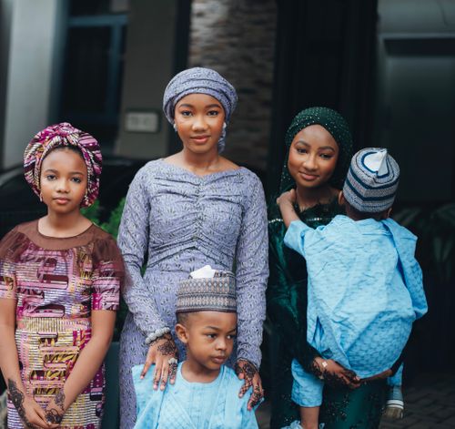 Free A charming portrait of a family dressed in colorful traditional attire, reflecting cultural elegance. Stock Photo
