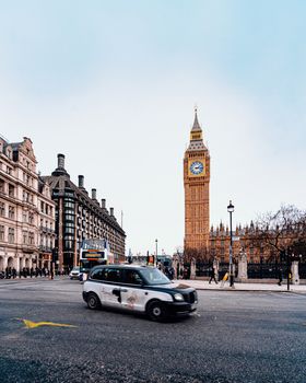 Capture the bustling street scene with Big Ben in London, featuring blue skies and classic architecture.