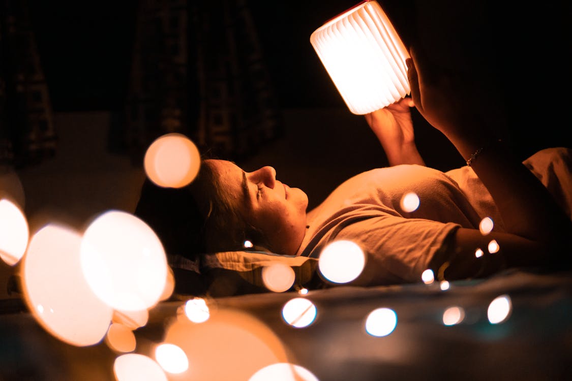 Photo Of Woman Holding Lamp