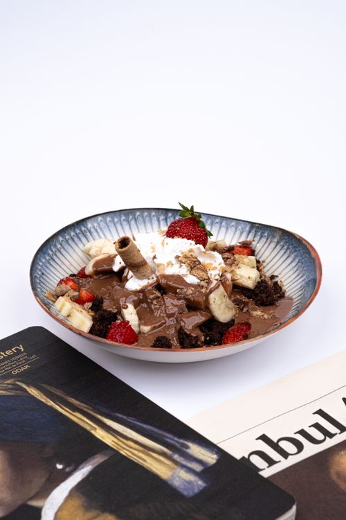 Free Close-up of a dessert bowl with chocolate, bananas, and strawberries. Stock Photo