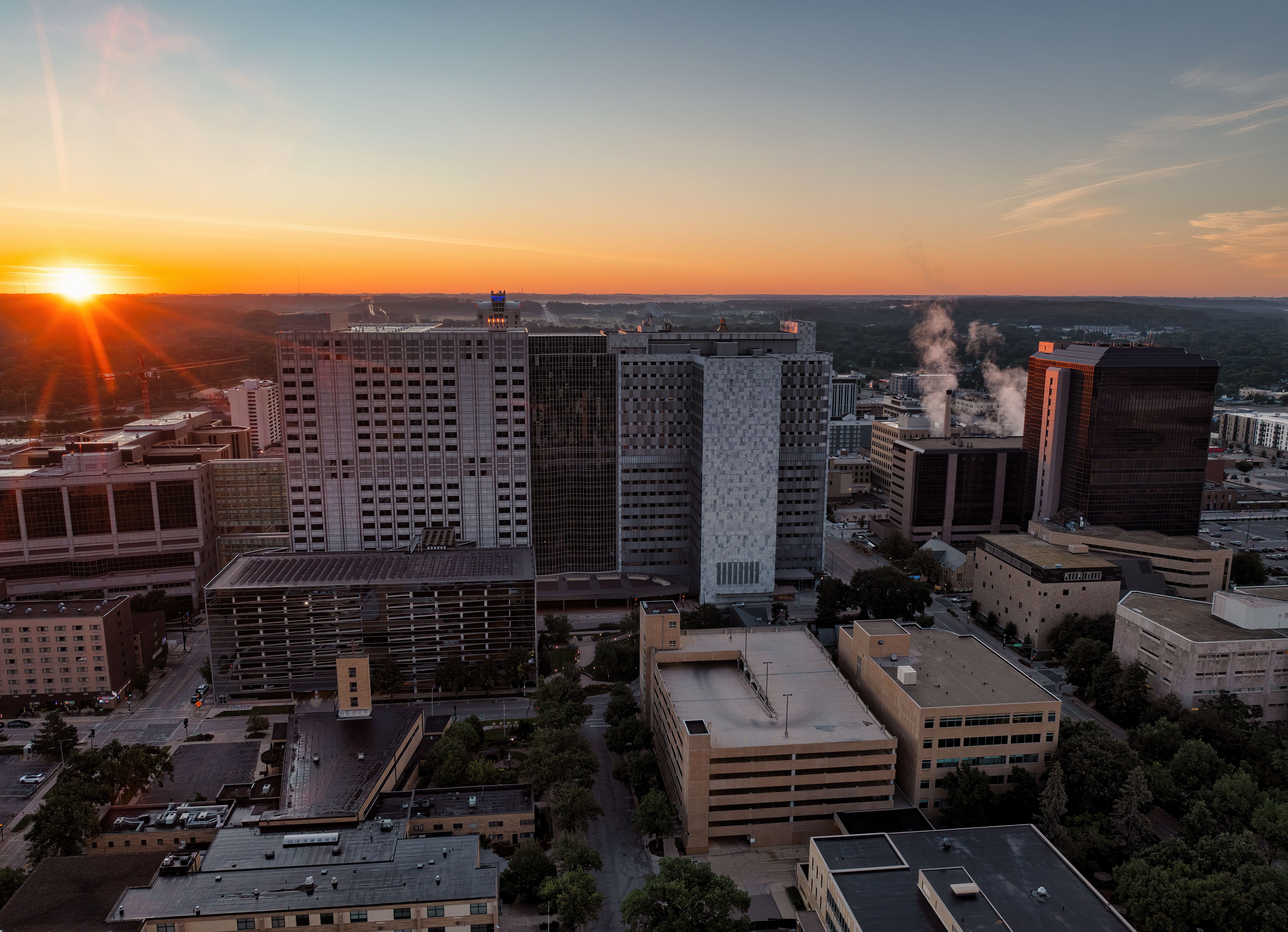 Aerial view of Rochester, Minnesota's skyline at sunset, showcasing modern architecture.