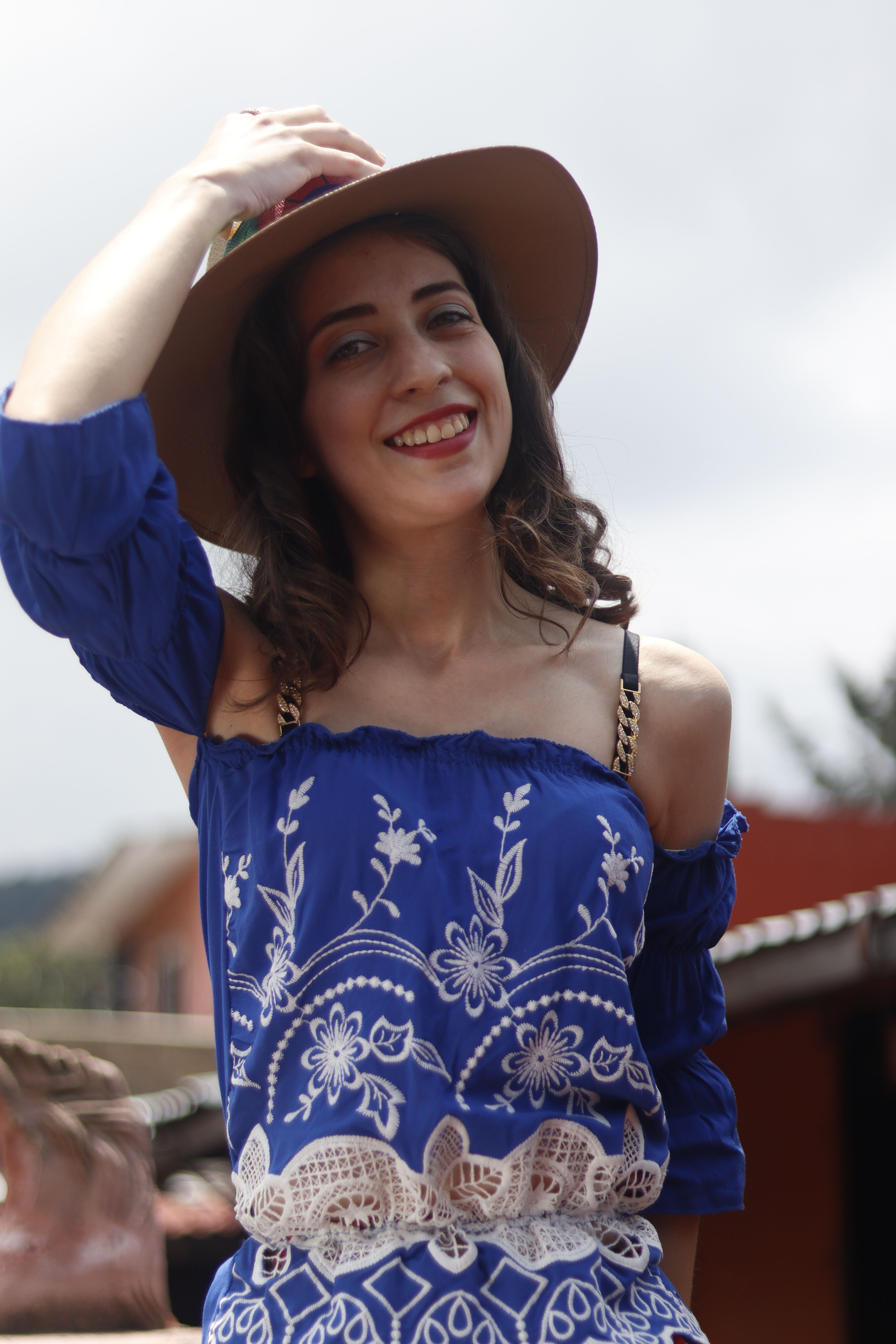 Smiling Woman in Blue Dress with Sun Hat Outdoors · Free Stock Photo