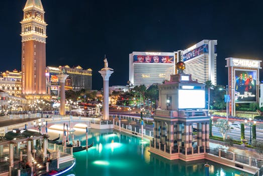 A stunning night view of Las Vegas Strip featuring illuminated landmarks and vibrant reflections. by David Vives