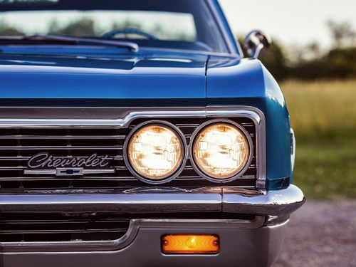 Free Front view of a vintage 1966 Chevrolet Caprice in blue showcasing headlights and grill. Stock Photo