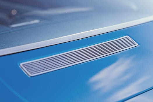 Detailed view of the rear vent on a vintage blue Chevrolet Caprice showcasing classic car design.