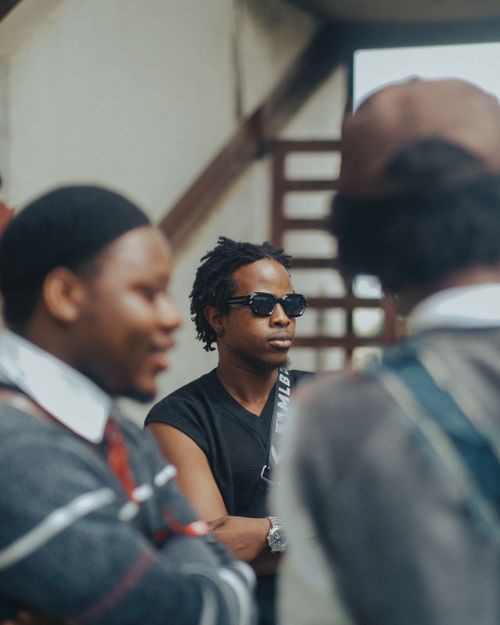 Free Group of African adults engaging in conversation outdoors in Ibadan, Nigeria. Stock Photo