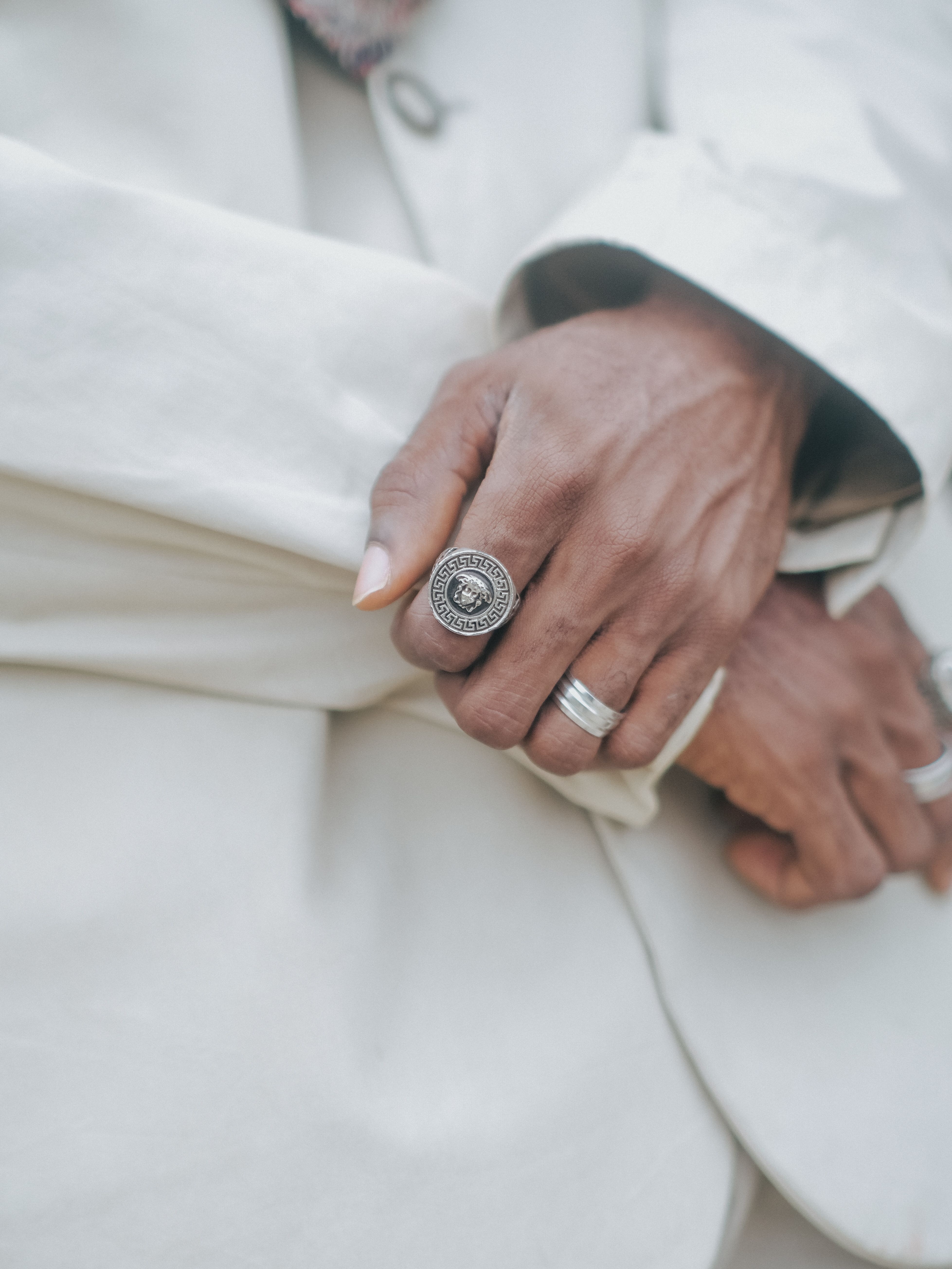 A man in a suit holding a ring on his hand · Free Stock Photo