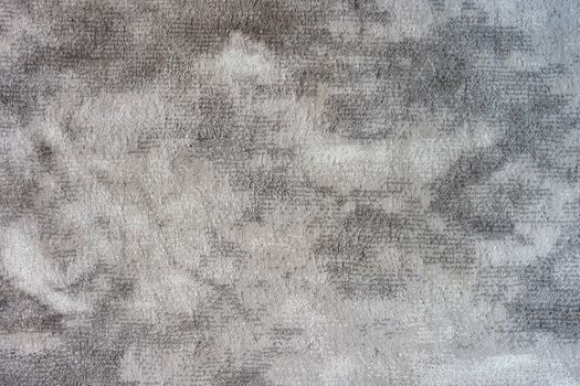 A textured gray concrete surface with an abstract pattern.