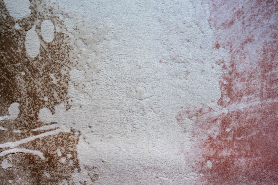 Abstract image featuring a textured surface with brown and pink tones.