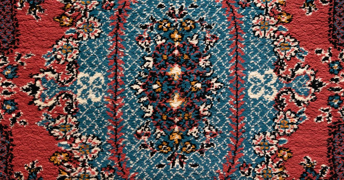 Blue Red Rug Texture A red and blue rug with floral designs · Free Stock Photo