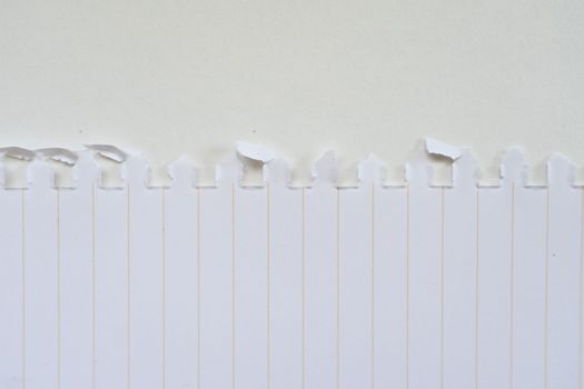 Minimalist design featuring torn paper resembling a fence pattern.